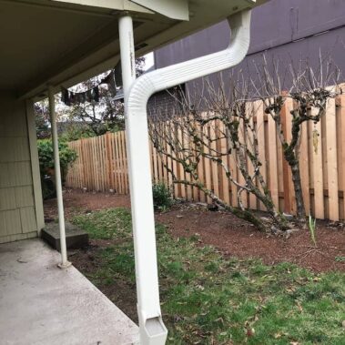 3x4 K-style gutter with extended downspout installation showing proper ground-level drainage solution for yard protection and water management