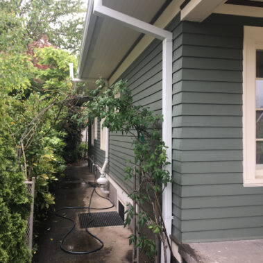 Royal Gutters' seamless white downspout and gutter system installation on Portland home. Professional craftsmanship. Call 503-558-8700
