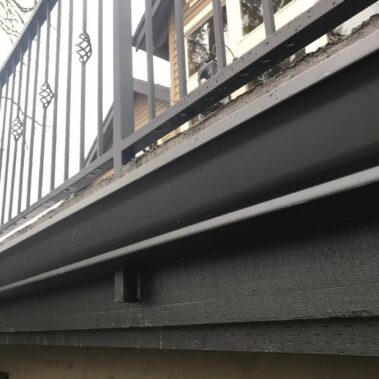 Black K-style gutter in action during rainfall, demonstrating effective water management and proper drainage on Portland home installation