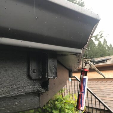 Black K-style gutter in action during rainfall, demonstrating effective water management and proper drainage on Portland home installation