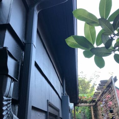Black K-style gutter installation on colonial home by Royal Gutters Portland, showcasing clean lines and professional mounting with architectural integration
