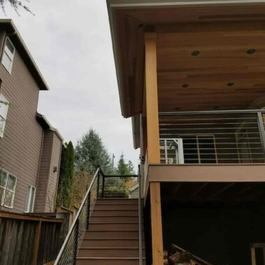 Box bottom gutter installation on modern deck with cable railing, showcasing contemporary design and increased water capacity for maximum drainage