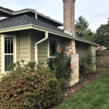Linen white gutters with oversized outlet on sage green craftsman home, providing enhanced water management while preserving architectural charm