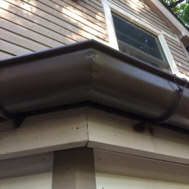 Royal Gutters' precision-crafted brown half-round corner installation. Expert Portland craftsmanship for seamless water management. 503-558-8700