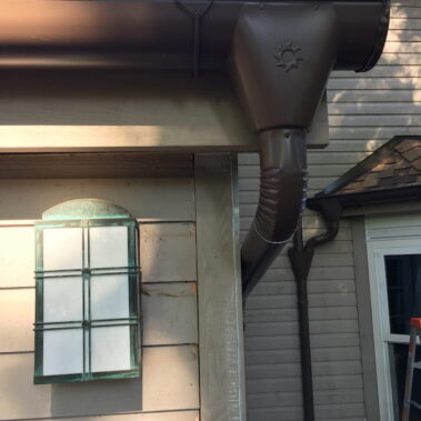 Royal Gutters' brown half-round gutter system with premium large outlet and decorative collector head. Expert Portland installation: 503-558-8700