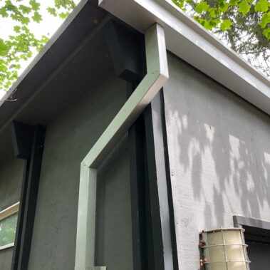 Royal Gutters Portland commercial square downspout system - durable white gutters with green trim for efficient water management