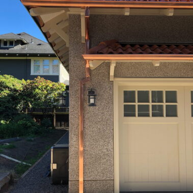 Royal Gutters' premium copper half-round gutters with concealed bracket system and square downspout. Elegant Portland craftsmanship. 503-558-8700