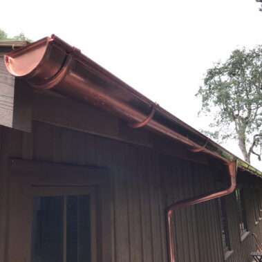 Royal Gutters' premium copper half-round gutter system with external brackets and custom downspout installation. Portland experts: 503-558-8700