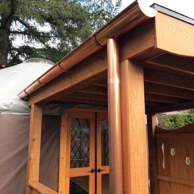 Copper Half-Round Gutter with External Brackets and Round Downspout