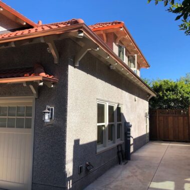 Royal Gutters' premium copper half-round gutters with hidden brackets, expertly installed on Portland Spanish-style home. Call 503-558-8700