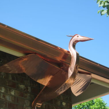 Custom copper heron leader head by Royal Gutters Portland - artistic downspout design combining beauty with functionality. Call 503-558-8700