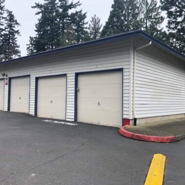 Box bottom gutter system with commercial-grade corner installation on garage, featuring high-capacity water management and durable design