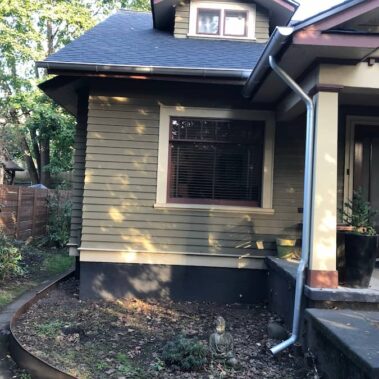 Royal Gutters' galvanized round downspout installation - efficient water management for Portland home entrances. 503-558-8700