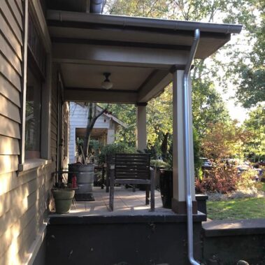 Royal Gutters' galvanized round downspout installation - modern design meets classic functionality for Portland homes. 503-558-8700