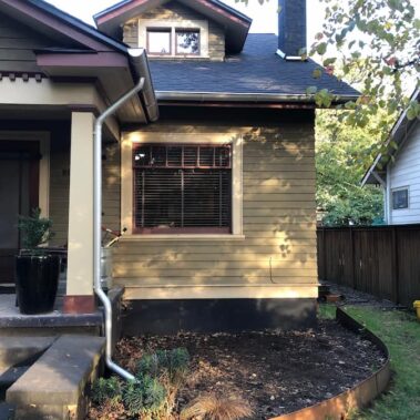 Royal Gutters' galvanized round downspout installation on Portland craftsman home - traditional style with modern protection. 503-558-8700