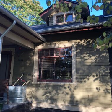 Royal Gutters' galvanized round downspout and half-round gutter system on Portland craftsman home. Expert installation: 503-558-8700