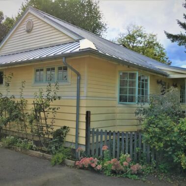 Royal Gutters' galvanized round downspout system on charming Portland home - complete water management solution. Call 503-558-8700