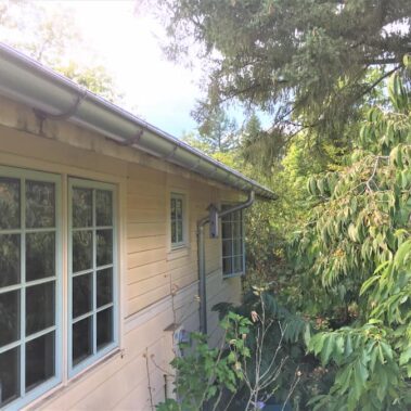 Royal Gutters' galvanized half-round gutter system with external brackets - complete Portland home protection. Call 503-558-8700