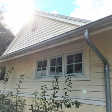 Royal Gutters' galvanized half-round system with external brackets - complete downspout installation. Portland experts: 503-558-8700