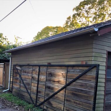 Royal Gutters' galvanized half-round gutters with round downspout - durable Portland installation for garages and outbuildings. 503-558-8700