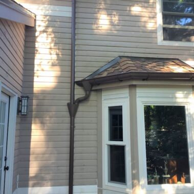 Royal Gutters' half-round gutter system with round downspout - classic styling for Portland homes. Professional installation: 503-558-8700