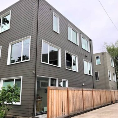 Modern Portland home featuring Royal Gutters' hidden gutter system with sleek square downspouts - professional installation for contemporary designs