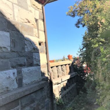 Royal Gutters' premium bronze downspout with curved elbow design - expert installation for Portland homes. Call 503-558-8700