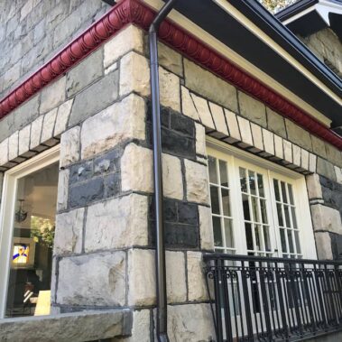 Royal Gutters' round downspout seamlessly connecting to K-style gutter - expert installation for Portland's unique homes. 503-558-8700