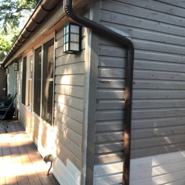 Royal Gutters' round downspout with max flow outlet - expert Portland installation for optimal drainage. Call 503-558-8700