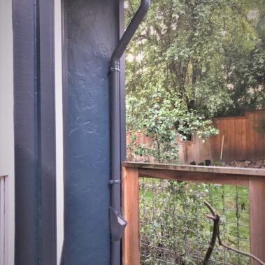 Royal Gutters' round downspout with Max Flow outlet and cleanout - complete water management solution for Portland homes. 503-558-8700