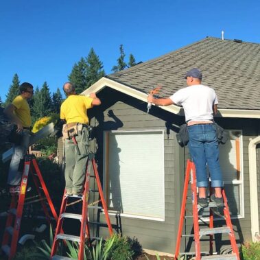 Royal Gutters Portland team expertly installing new gutters on residential home. Professional service, free estimate: 503-558-8700