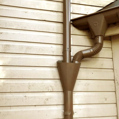 Royal Gutters Portland professional downspout installation - premium brown aluminum system with custom collector box and precise angles