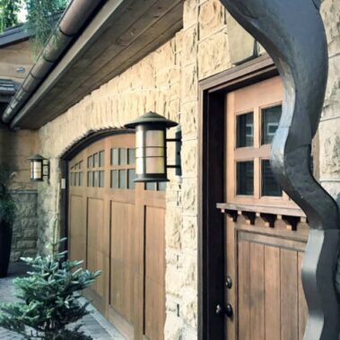 Royal Gutters Portland custom fish-shaped artistic downspout - luxury stone facade installation with decorative water management