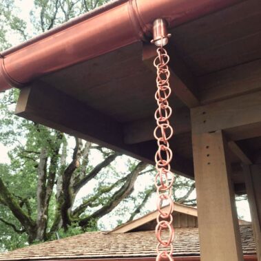 Copper rain chain installation by Royal Gutters Portland - decorative water feature enhancing home drainage, professional gutter solutions