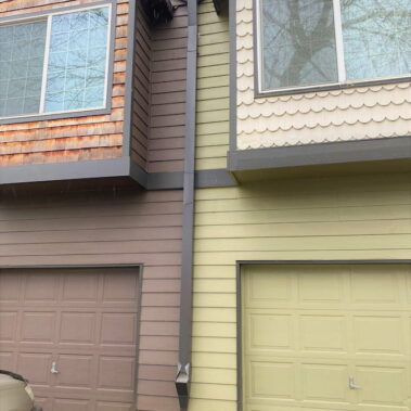 Royal Gutters' smooth square downspout with cleanout feature - professional installation on Portland home. Expert service: 503-558-8700