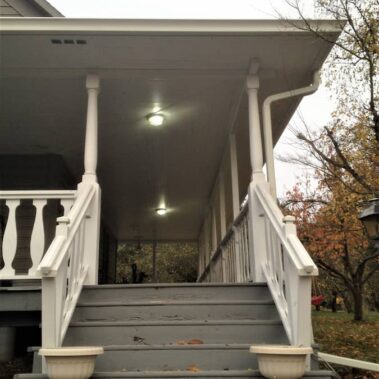 Royal Gutters' Spanish curved gutter system with decorative downspout - elegant porch installation showcasing architectural integration. 503-558-8700