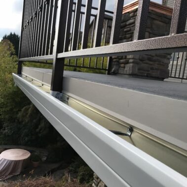 Royal Gutters' wide-bottom deck gutter system with fascia hangers. Specialized Portland patio protection. Free estimate: 503-558-8700