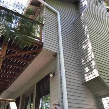 Royal Gutters' white square downspout installation - seamless integration for Portland homes. Expert service: 503-558-8700