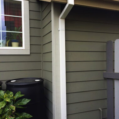 Royal Gutters' custom-matched white square downspout installation - seamless K-style gutter integration for Portland homes. Call 503-558-8700