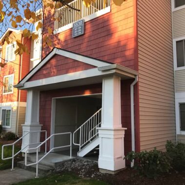 Royal Gutters' white square downspout system with Max Flow technology - professional installation on Portland multi-family property. 503-558-8700