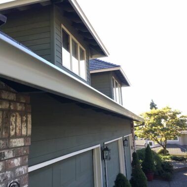 Royal Gutters' white Spanish curved gutters enhancing Portland multi-story home. Seamless integration, expert installation. 503-558-8700
