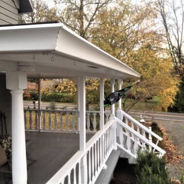 Royal Gutters' elegant white Spanish curved gutter system enhancing Portland home's porch design. Custom installation by experts. 503-558-8700